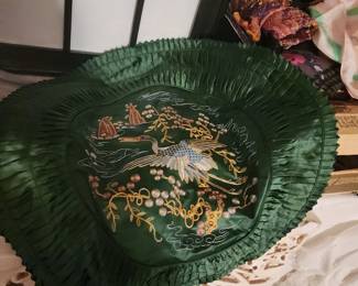  round, dark green, embroidered silk pillow cover with a crane and floral pattern. 