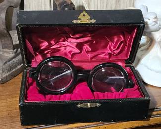  vintage novelty or gag glasses, sometimes referred to as "bottle-bottom" or "nerd" glasses in a black case with a red velvet interior. 