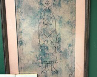 This is framed and known as the "Standing Figure" by Swiss-German artist Paul Klee (1879-1940) known for his childlike, whimsical style. The lower-left corner features a book on Paul Klee titled KLEE, by Nello Ponente.