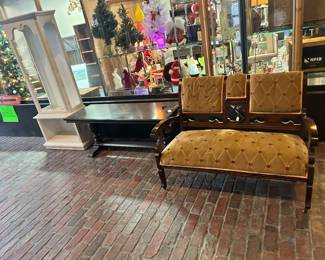 Three pieces of furniture, including settee, long low table.