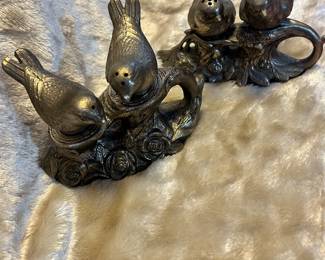 pair of salt and pepper shakers sitting on a cast metal base
