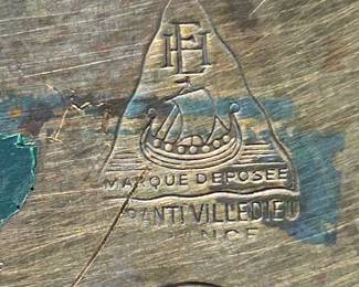 A close up of the mark on the bottom of the Marque DePosee French copper spirit/tea kettle.