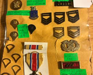 An assortment of military insignias, medals...