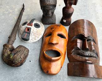 Carved African Head vase, masks and one heck of a smoking pipe. NOTE!!!!! the top row - tall wood carving of a lady was done by the renowned African-American artist Al Samuels. Mr. Samuels passed away in 2017. Round ~10” diameter wood