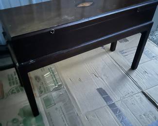a piano bench with lift top lid
