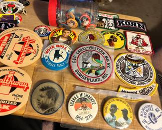 A wonderful selection of the various buttons and advertising pieces for sale. Including Fort Atkinson Healthway milk, lids, Milwaukee, Brewers baseball Tide buttons from the 1970s featuring Hank, Aaron and Robin Young, and patches of interest.