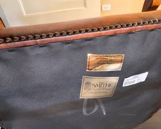 Walter E. Smithe English Georgian Style "Campaign" Chair Upholstered in Tobacco Leather and Matching Ottoman with Nailhead Trim. Measures 26" W x 30" D. Photo 7 of 7.