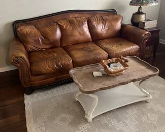 Leather sofa, coffee table and rug