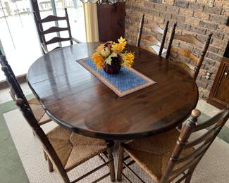 Bent Rims table by Jefferson Woodworking Co. (Louisville, KY), with two leaves and six ladder-back chairs with rush seats.