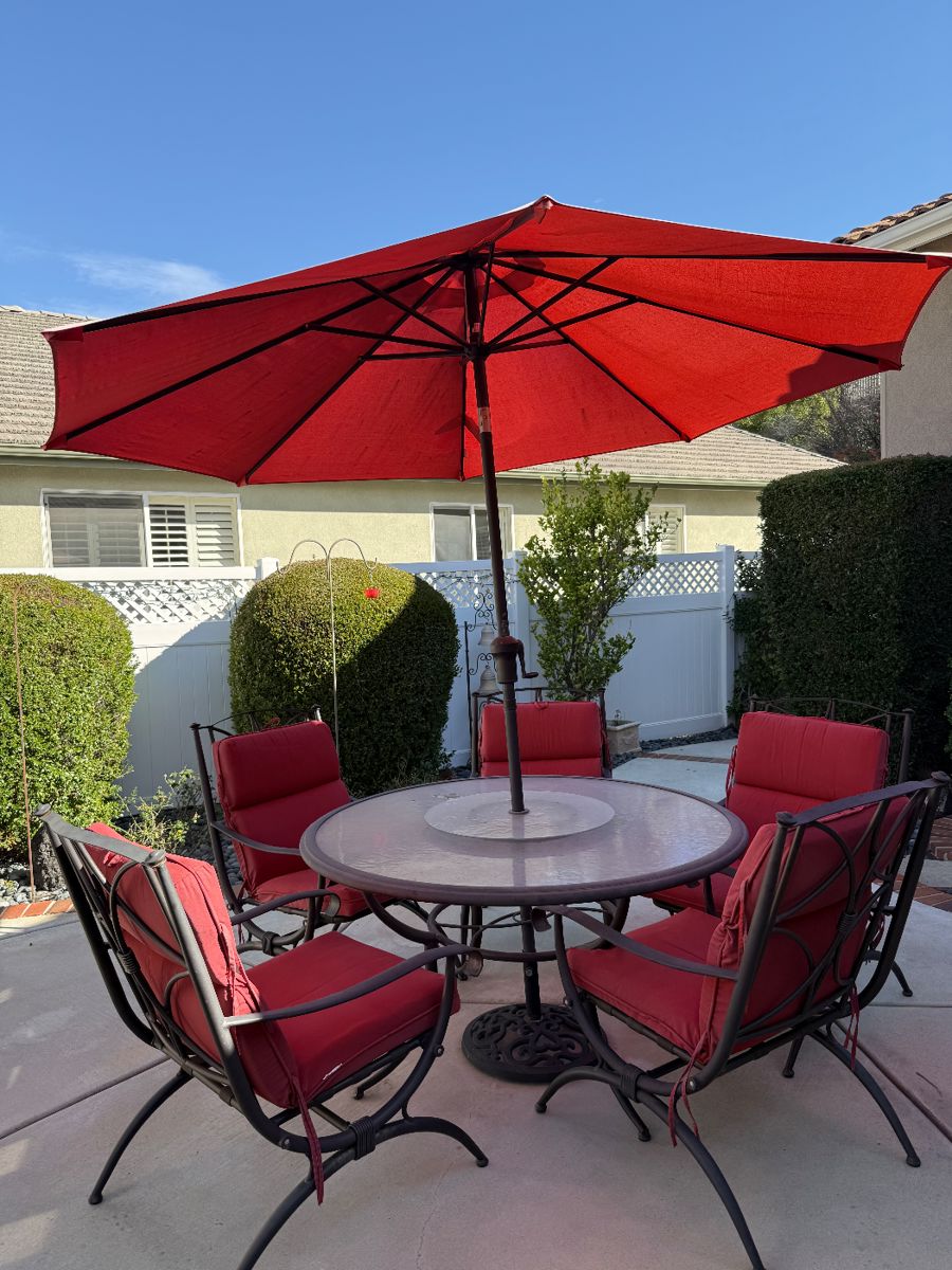 Clean and sturdy patio table w built in lazy susan. 6 deep seated chairs w/ cushions. NO RUST. 