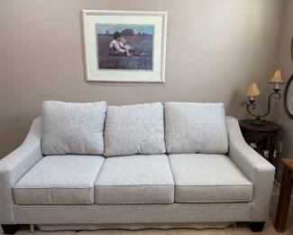 NEW sofa bed. Full. Wall decor, end tables and lamp.