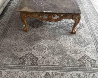 Area rug and marble coffee table.