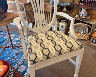 shield back armchair with a white frame and patterned seat cushion