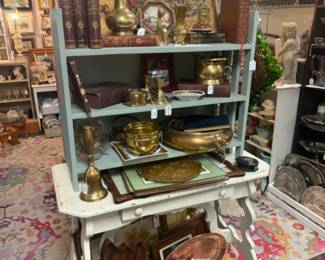 beautiful white painted table, brass and copper pieces, vintage books, framed art