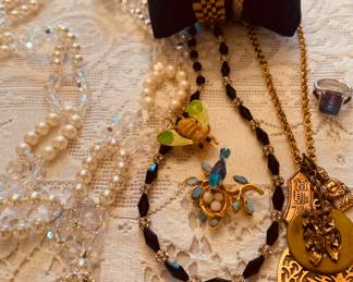 Box filled with vintage jewelry. 