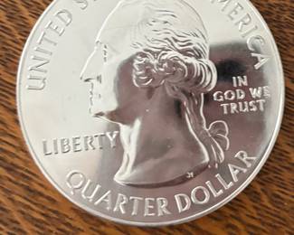 The 2017 5 oz silver Iowa Effigy Mounds National Monument coin is part of the U.S. Mint's America the Beautiful (ATB) series, featuring 5 troy ounces of .999 fine silver. Released as a 3-inch diameter collector item, it features a "P" mint mark for Philadelphia and a burnished, matte finish
