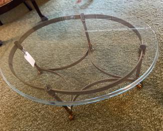 Hollywood Regency La Barge-style brass and glass coffee table with hooved feet.