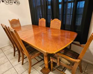 Large table with leaf and 6 chairs. Wicket Backing in some chairs needs to be replaced or repaired.