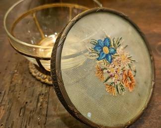 C. 1920 dressing table powder jar/ trinket catch all with delicate floral needlepoint lid encased in glass