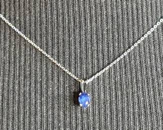 This lot features a sapphire pendant set in sterling silver on a 925 chain measuring, 17”.

