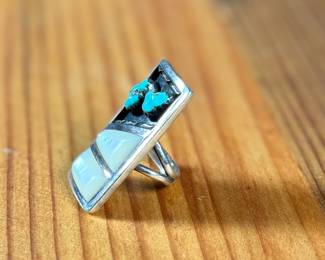This lot features a beautiful Zuni ring, handcrafted by artist, Florentine Panteah. Signed by the artist and originally purchased in Jackson Hole, Wyoming. This ring comes in a size 5 and has a total approx. weight of 13.56 grams.

