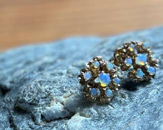 This lot features a pair of stunning 14k gold earrings, each containing seven (7) opals, circa 1940s. Total approx. weight of 2.58 grams.

