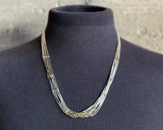 This lot features a stunning liquid silver and 14k gold necklace measuring, 23” with a total approx. weight of 27.57 grams.


