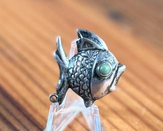 This lot features a vintage Taxco sterling silver “fish” pin.

