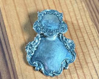 This lot features a sterling silver luggage tag by Foree that measures, 2.5” H x 1.75” W and has a total approx. weight of 30.52 grams.

