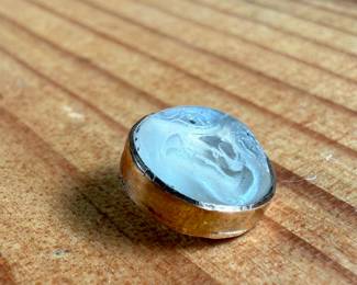 This lot features a carved "moon" moonstone set in 14k gold with a total approx. weight of 1.19 grams.

