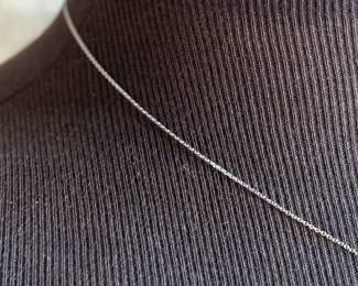 This lot features a sapphire pendant set in sterling silver on a 925 chain measuring, 17”.

