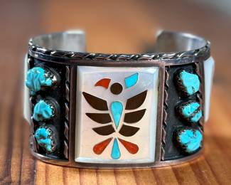This lot features a beautiful handcrafted Zuni cuff by artist, Florentine Panteah. The cuff measures, 7” and has a total approx. weight of 99.80 grams. 

