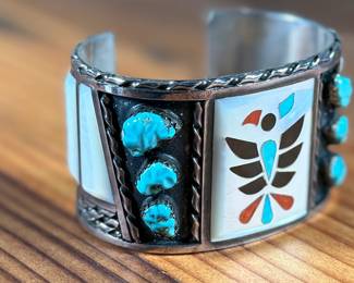 This lot features a beautiful handcrafted Zuni cuff by artist, Florentine Panteah. The cuff measures, 7” and has a total approx. weight of 99.80 grams. 

