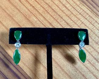 This lot features a pair of 14k gold earrings with genuine diamonds and jade. This set has a total approx. weight of 4.30 grams.

