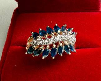 This lot features a stunning 14k gold two-tone diamond & sapphire ring. Accompanied with an appraisal, this ring comes in a size 7.75 and a total approx. weight of 4.6 grams. This ring contains fourteen (14) marquise cut sapphires and nine (9) single cut diamonds.

