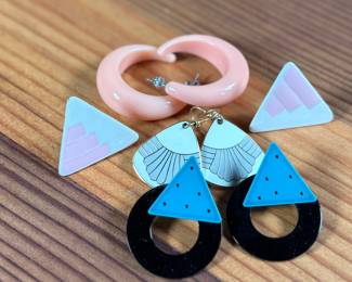 This lot features a curated collection of mid-century style earrings including a pair by Laurel Burch.

