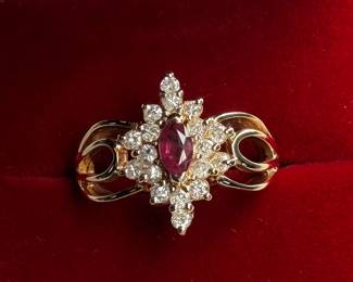 This lot features a 14k yellow gold ring with sixteen (16) round single cut genuine diamonds and one (1) marquise cut ruby. Accompanied with an appraisal, this ring comes in a size 7.75 with a total approx. weight of 4.6 grams.


