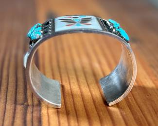 This lot features a beautiful handcrafted Zuni cuff by artist, Florentine Panteah. The cuff measures, 7” and has a total approx. weight of 99.80 grams. 

