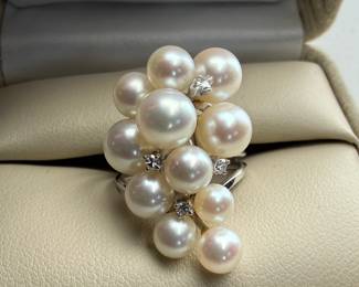 This lot features a 14k white gold ring with genuine pearls and white sapphires. This ring comes in a size 5.5 with a total approx. weight of 7.14 grams.

