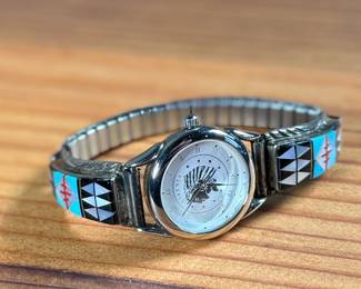 This lot features a beautiful artisan made Zuni watch band that appears to be signed by artist, "RB" as shown in photos.

