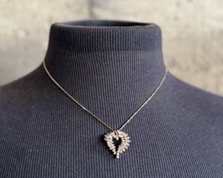 This lot features a stunning diamond heart pendant set in 14k gold on a 14k gold chain. The chain measures, 18” and this piece has a total approx. weight of 8.85 grams. The pendant contains genuine diamonds with a 1.50 carat weight.

