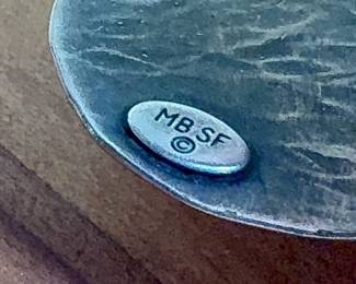 This lot features a cuff bracelet by designer, Marjorie Baer. Signed as shown in photos and measures, 7”.

