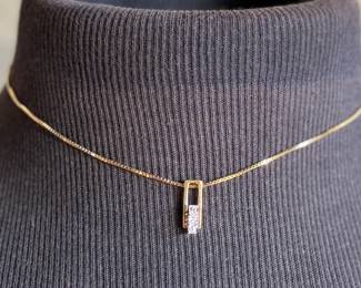 This lot features a stunning 18k gold pendant with genuine diamonds on a gold chain measuring, 16”. Marked 750 with a total approx. weight of 5.03 grams.

