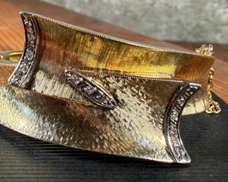 This lot features an incredible hand made 18k gold & diamond Art-Deco bangle bracelet with an integrated box clasp and safety chain. Accompanied with an appraisal from Reliant Gem Lab, this bracelet has a total approx. weight of 41.71 grams and .23 ct of thirteen (13) bead set single cut diamonds. 

