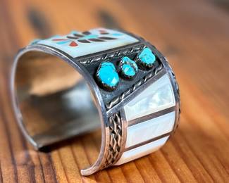 This lot features a beautiful handcrafted Zuni cuff by artist, Florentine Panteah. The cuff measures, 7” and has a total approx. weight of 99.80 grams. 

