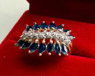 This lot features a stunning 14k gold two-tone diamond & sapphire ring. Accompanied with an appraisal, this ring comes in a size 7.75 and a total approx. weight of 4.6 grams. This ring contains fourteen (14) marquise cut sapphires and nine (9) single cut diamonds.

