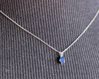 This lot features a sapphire pendant set in sterling silver on a 925 chain measuring, 17”.

