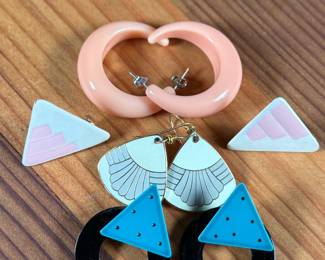 This lot features a curated collection of mid-century style earrings including a pair by Laurel Burch.

