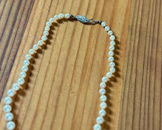 This lot features a graduated genuine pearl necklace with a 10k gold clasp measuring, 13”.

