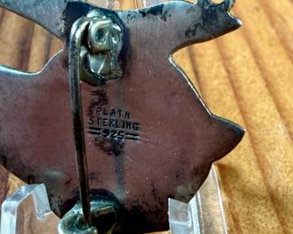 This lot features a vintage Taxco sterling silver “fish” pin.

